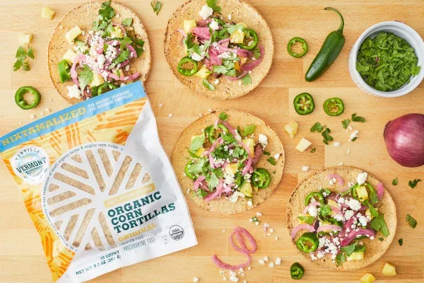 Topped corn tortillas with herbs, sliced jalapenos and a package of Original tortillas