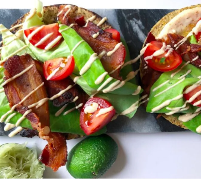 Corn tortilla tacos filled with crisp bacon, lettuce and cherry tomatoes, drizzled with lime mayonnaise
