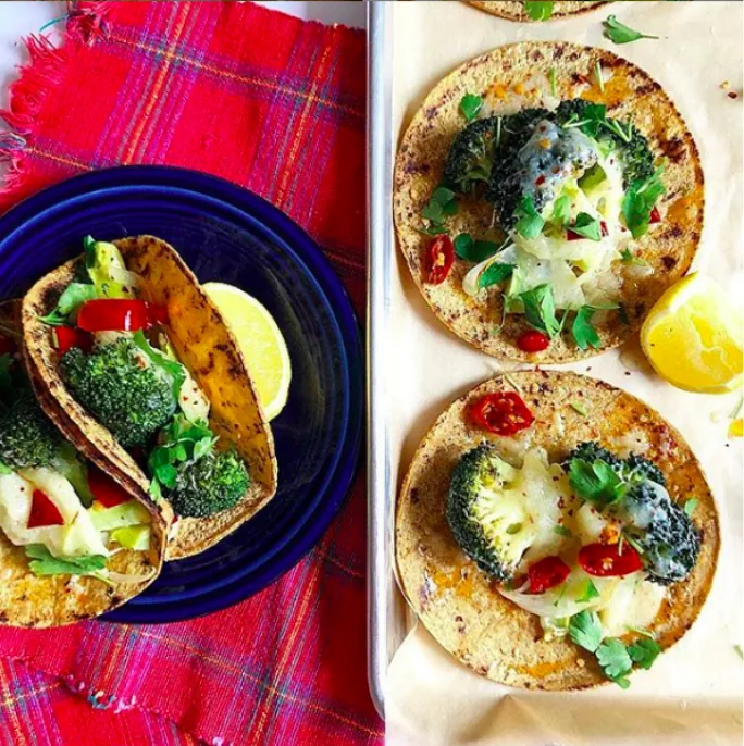 Corn tortilla tacos with roasted broccoli, melted cheddar, pickled red peppers and parsley, served with lemon wedges