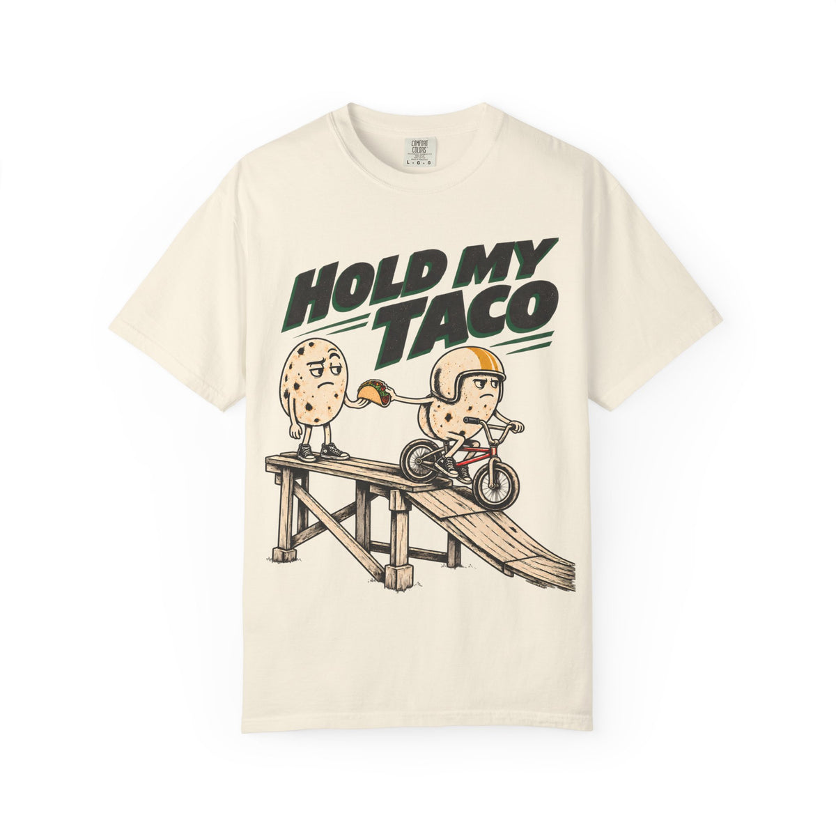 Ivory Hold My Taco T-shirt, front with Hold My Taco lettering and tortilla characters at a bicycle ramp