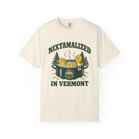 Ivory Nixtamalized in Vermont T-shirt, front with Nixtamalized in Vermont lettering, three corn kernels in a steaming green pot, snowy evergreens, and the Vermont Tortilla Company emblem
