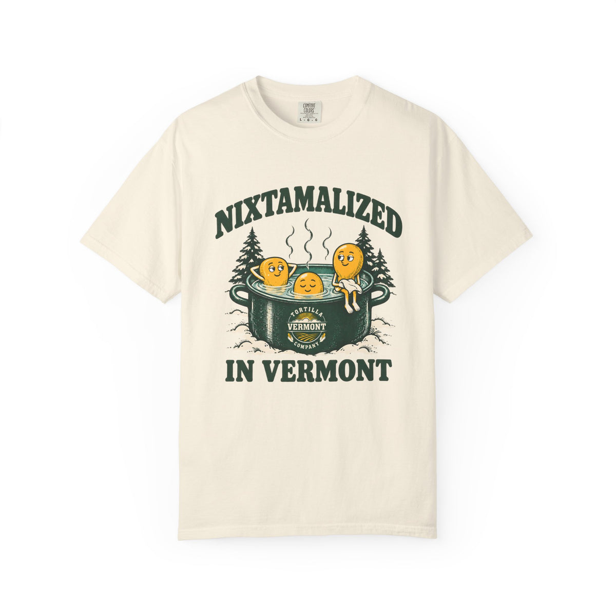 Ivory Nixtamalized in Vermont T-shirt, front with Nixtamalized in Vermont lettering, three corn kernels in a steaming green pot, snowy evergreens, and the Vermont Tortilla Company emblem