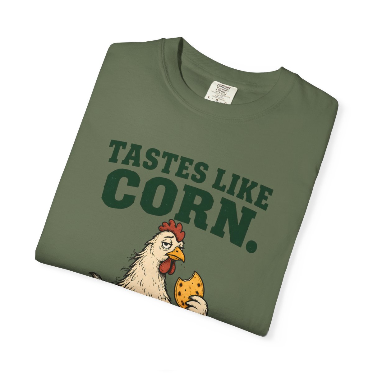 Sage Tastes Like Corn T-shirt, folded close-up of the Tastes Like Corn lettering and chicken artwork