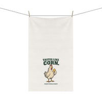 Tastes Like Corn white cotton twill tortilla towel hanging from a line, showing the chicken artwork and lettering